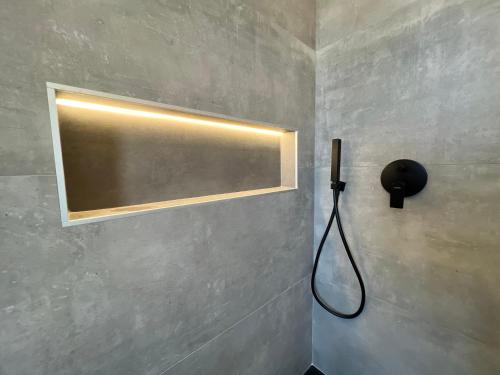 a light on a wall in a bathroom at Arena appartments in Savona