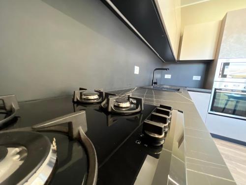 a kitchen with a stove and a counter top at Arena appartments in Savona
