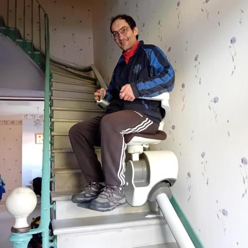 a man sitting on a toilet in a room at Pradines in La Celle-sous-Gouzon