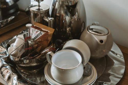 a table with a tea pot and a cup on it at Highside Farm in Bassenthwaite