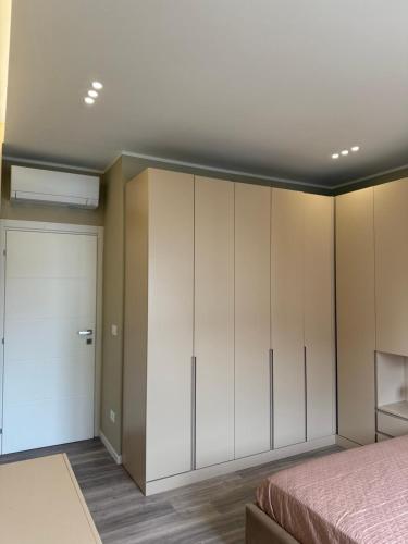 a bedroom with white cabinets and a bed at Arena appartments in Savona