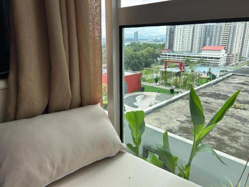 a room with a window with a pillow and a plant at Lovely Luxury Poolview in Kajang