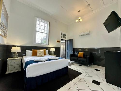 a bedroom with a bed and a flat screen tv at Charlesworth On The Park in Glen Innes