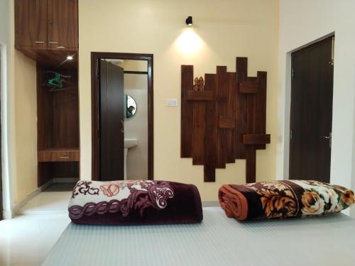 a room with two ottomans sitting on the floor at Resort Morning Glory in Lataguri