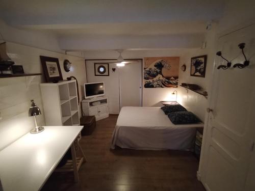 Cette petite chambre comprend un lit et une télévision. dans l'établissement Bel appartement Port Sanary, à Sanary-sur-Mer