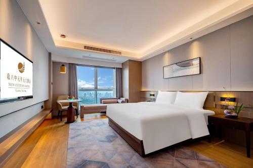 Giường trong phòng chung tại New Century Mansion Hotel Jiaxing Zhongyuan Nanhu Avenue