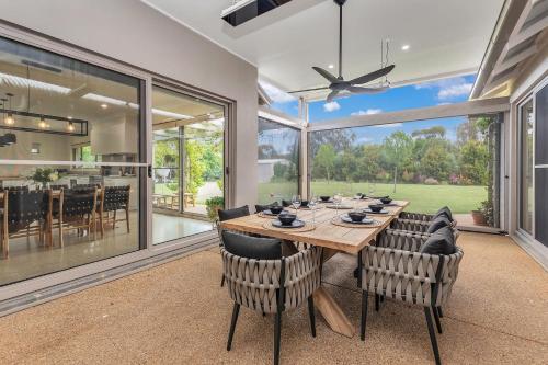 a large dining room with a table and chairs at Moama on Clarke - Echuca Holiday Homes in Moama