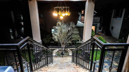 a staircase leading to a house with a chandelier at Ondjo Yetu in Benoni