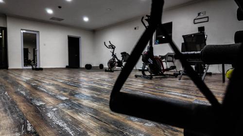 a gym with a wooden floor and a room with exercise equipment at Ondjo Yetu in Benoni