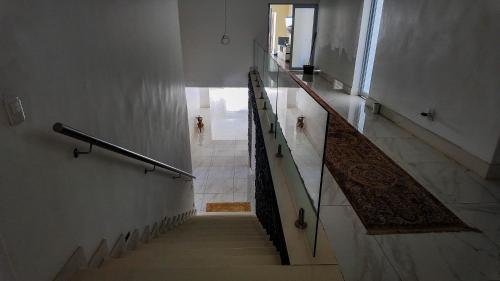 a hallway with stairs in a building with a rug at Ondjo Yetu in Benoni