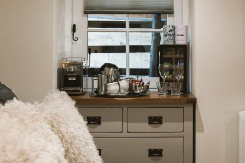 a dresser in a room with a window at Highside Farm in Bassenthwaite