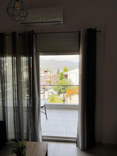 a room with a window with a view of a balcony at Barounia Suite in Iraklitsa