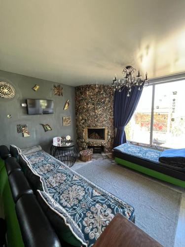 a bedroom with a couch and a fireplace at Happy home in Ak-Terek