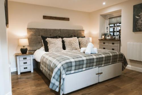 a bedroom with a large bed and a nightstand with a bed sidx sidx sidx at Highside Farm in Bassenthwaite