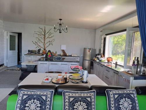 a kitchen with a table and chairs in a room at Happy home in Ak-Terek