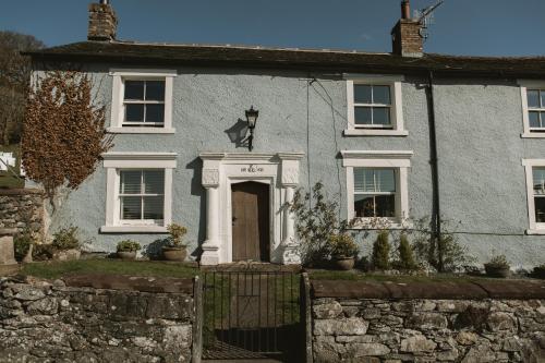 a blue house with a gate in front of it at Highside Farm in Bassenthwaite