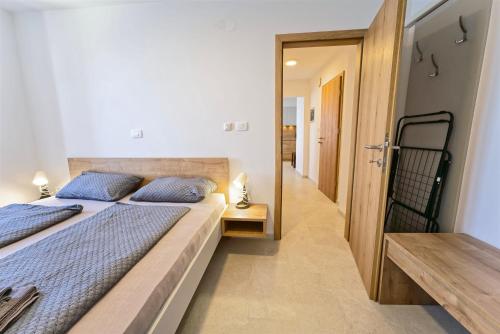 a bedroom with a large bed and a mirror at Apartments Punta Piran in Piran