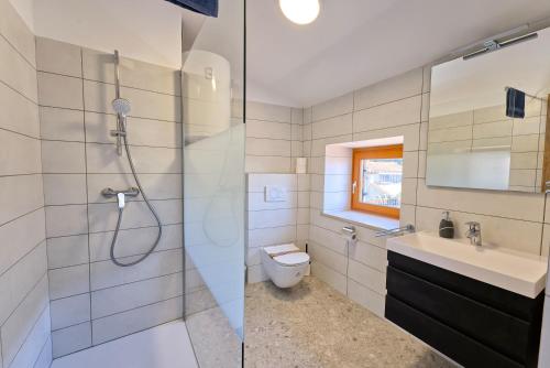 a bathroom with a shower and a toilet and a sink at Apartments Punta Piran in Piran