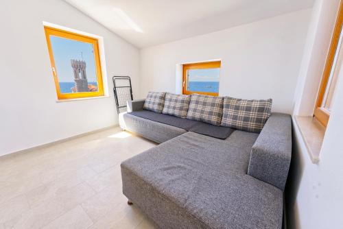 a living room with a couch and a chair at Apartments Punta Piran in Piran