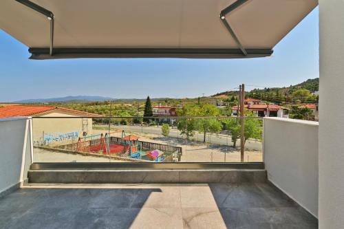 a balcony with a view of a playground at Agios Nikolaos Villas in Ayios Nikolaos Sithonia