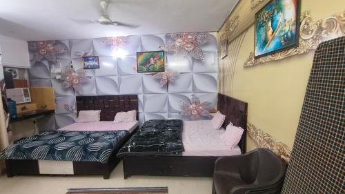 a room with two beds in a room at Omaxe Eternity Family Stay- Near Prem Mandir in Vrindāvan