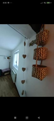 a room with baskets hanging on a wall at Nature et sérénité à St Jean de Sault in Sault-de-Vaucluse