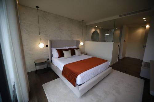 a bedroom with a large bed and a mirror at Quinta Vale de Lobos in Folgosa