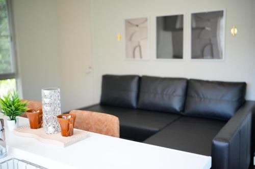 a living room with a table and a couch at グランピング宿 星空テラス&暖炉の庭付き戸建 Orion in Miyamae