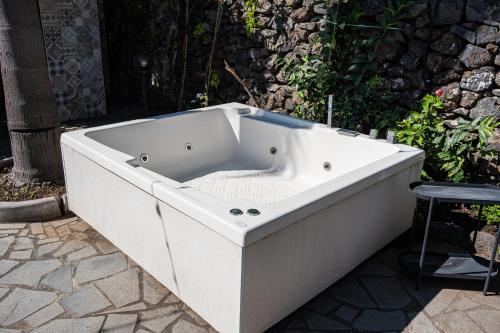 a white bath tub sitting on a patio at Casa Scala in Acireale