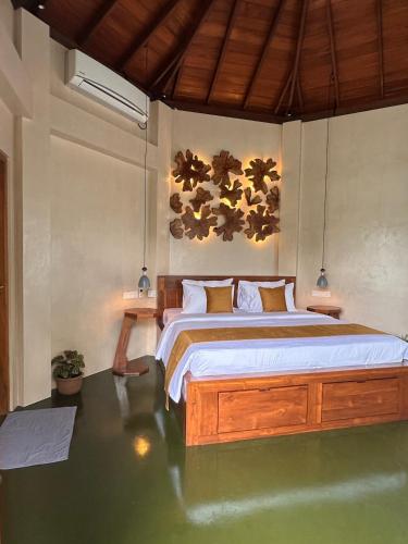 a bedroom with a large bed in a room at Romantic Jungle Hideaway in Tangalle