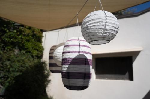 a group of three lights hanging from a building at Casa Scala in Acireale