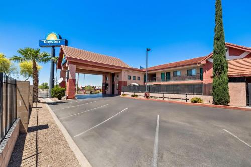 a hotel with a parking lot in front of it at Days Inn by Wyndham Tucson Airport in Tucson
