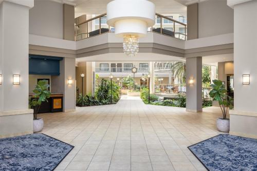 a lobby at the resort with a large chandelier at Embassy Suites Birmingham in Birmingham