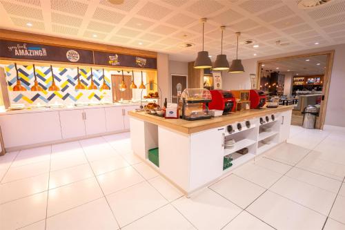 a fast food restaurant with a counter in a store at Hampton By Hilton Bristol Airport in Redhill