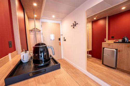a kitchen with a coffee maker on a counter at Hampton By Hilton Bristol Airport in Redhill