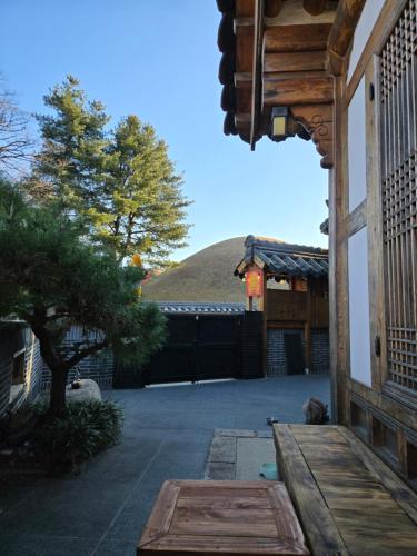 a patio with a wooden bench on a building at Hanok Myeongdang in Gyeongju
