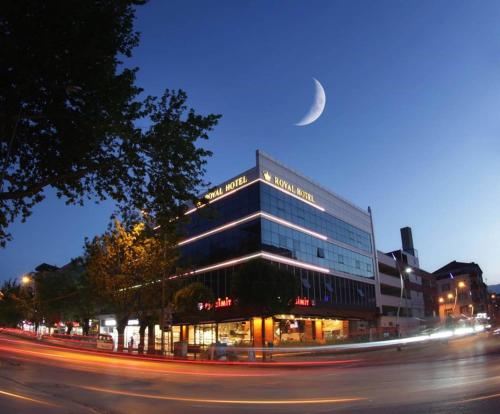 a building on a street with a moon in the sky at Royal Hotel Inegol in Inegol