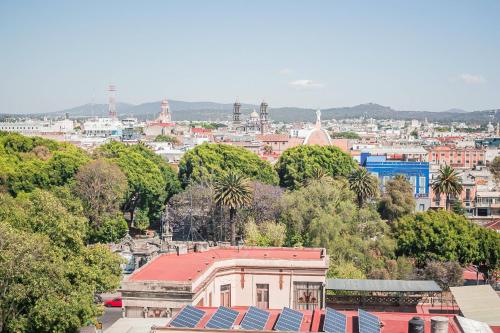 a view of a city with trees and buildings at Comfort Inn Puebla Centro Hist rico in Puebla