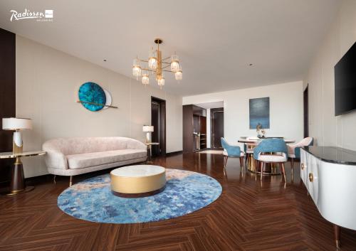 a living room with a couch and a table at Radisson Blu Ha Long Bay in Ha Long