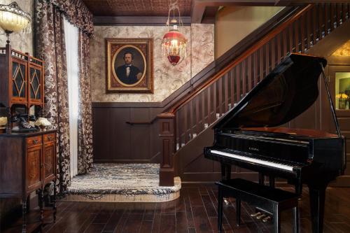 a staircase with a piano in a room at National Hotel Jackson, Tapestry Collection by Hilton in Jackson