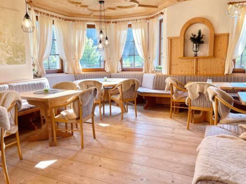 a dining room with tables and chairs and windows at Apartment in Lackenhof with swimming pool in Lackenhof