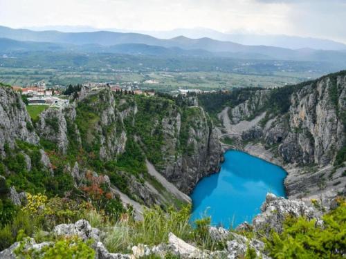 a view of a blue lake in a canyon at Adorable holiday home with swimming pool in Imotski