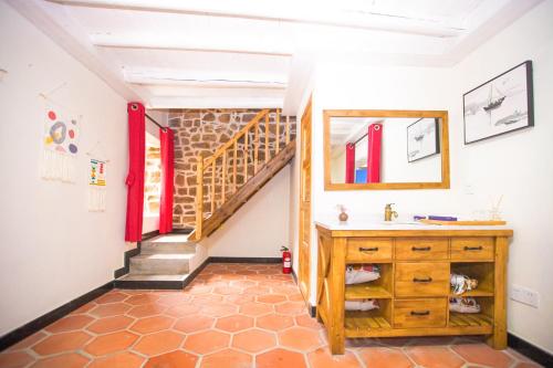 a room with a staircase and a wooden dresser at 平潭游记猫头墘古村落 in Pingtan