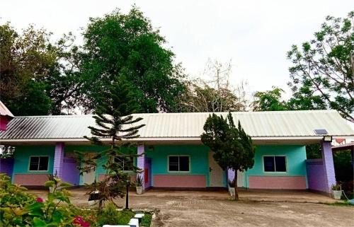 a colorful house with a tin roof at เมืองเลยแอร์พอร์ทโฮเทล in Loei