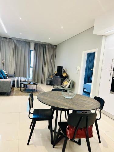 a living room with a table and chairs at Itowers Luxury Apartment in Gaborone