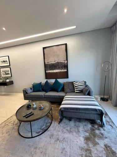 a living room with a couch and a coffee table at Itowers Luxury Apartment in Gaborone