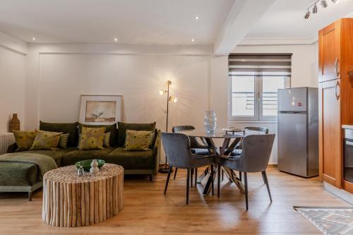 a living room with a couch and a table at Delimare, Acropolis & Sea View Rooftop, Paleo Faliro in Athens