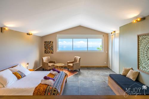 a bedroom with a large bed and a window at Villa Eden... pour un séjour parfait! in Saint-Leu