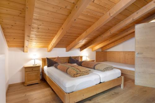 a bedroom with a bed in a room with wooden ceilings at Kramer in Garmisch-Partenkirchen