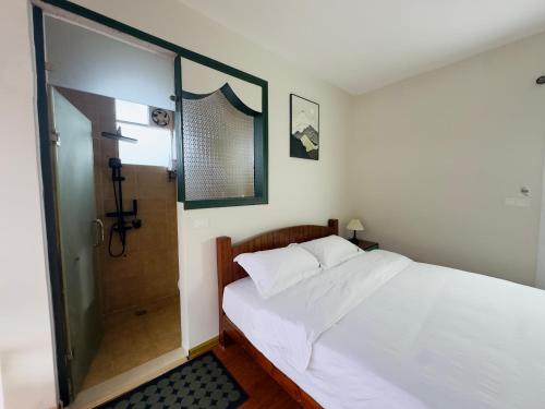 a bedroom with a bed and a shower at Xunyan B&B in Yangshuo